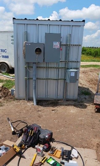SCI Electrical technician working on a panel install at a metal building in South Texas